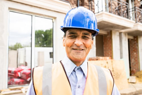 Preview: Portrait of confident indian male construction worker at construction site