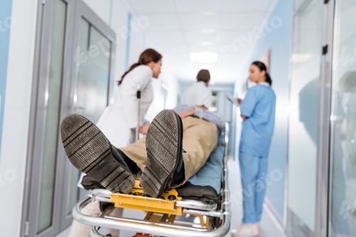 Preview: Doctors transporting patient on gurney to operating room