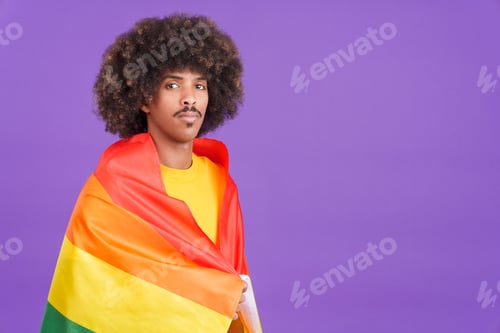 Preview: Serious african man wrapped with a lgbt flag