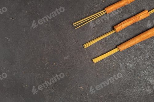 Preview: top view raw italian pasta yellow colored with cinnamon on the dark desk food meal raw italy pasta