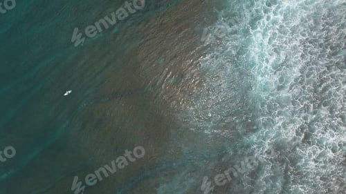 Preview: Aerial view of surfer in clear sea