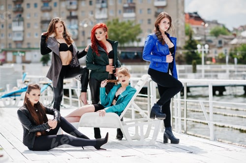 Preview: Group of sexy models girls in black bra and leather jackets on the dock