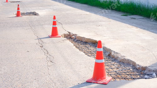Preview: Renovate the old damaged road with Reinforcement steel structure and traffic cones on street surface