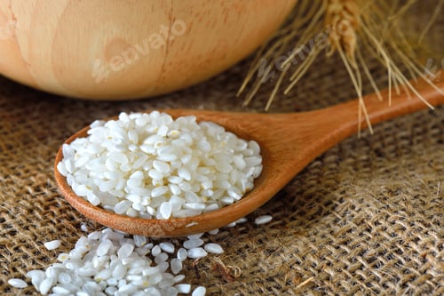 Rice Grains in Wooden Spoon with Bowl