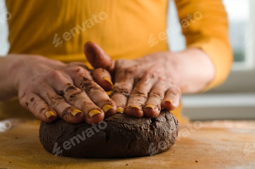 Preview: Ball of dough and cocoa pressed to a wooden board with your hands