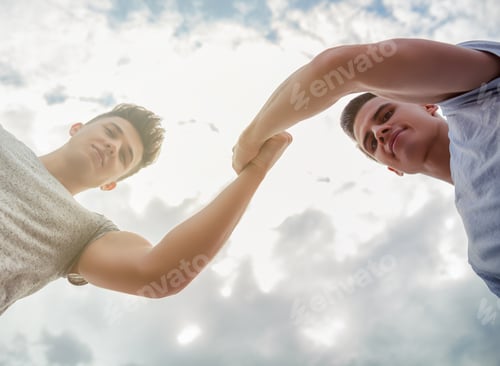 Preview: Two friends giving high five on sky background, motivation and success