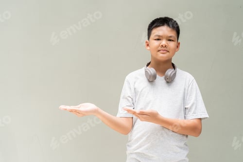 Preview: Thai Boy Portrait Against Plain Wall in Natural Light