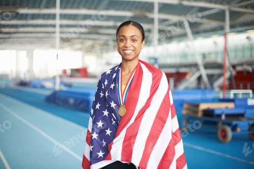 Preview: Young female athlete wrapped in US flag with gold medal