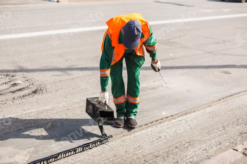 Preview: The man working asphalt pouring tar for road repair