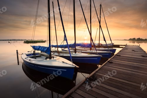 Preview: serene charming harbor at sunrise with yachts