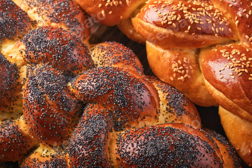 Preview: Shabbat Shalom. Bread challah with sesame seeds and poppy seeds on wooden background. Traditional je