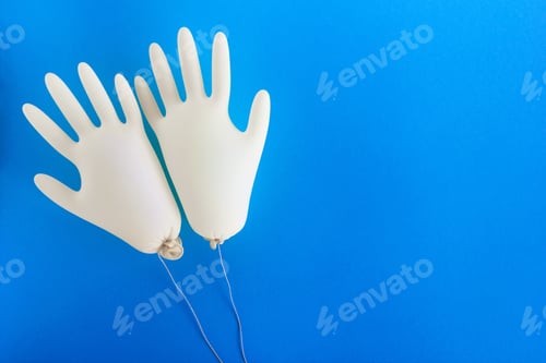 Preview: Pair of disposable medical gloves on blue background with copy space.