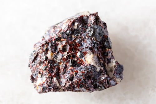 Preview: raw franklinite and zincite minerals on white