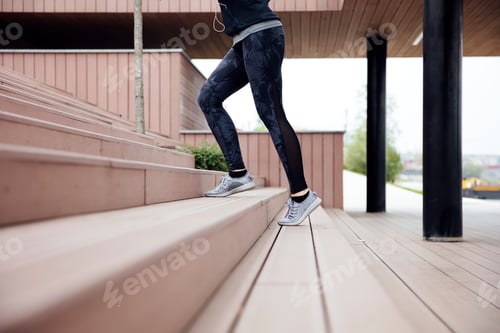 Preview: Fit young woman running on steps