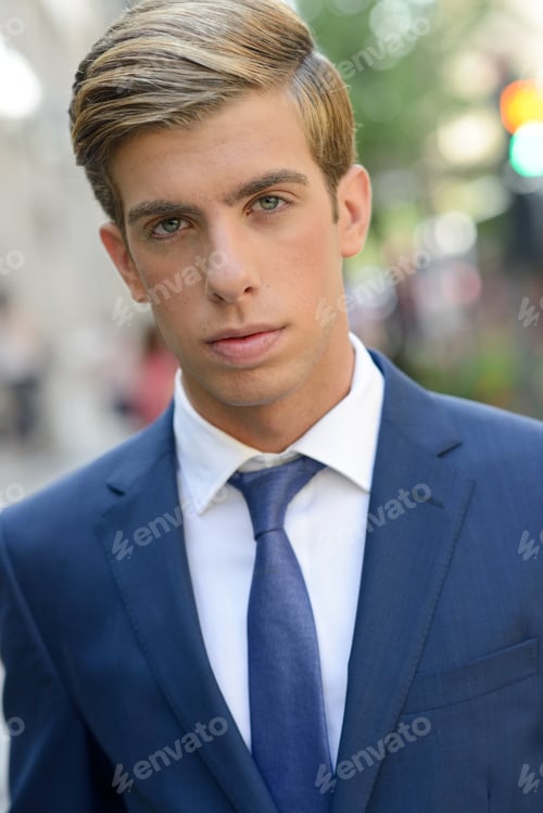 Preview: Attractive young businessman in urban background