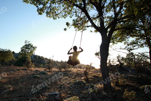Preview: girl swinging freely in nature