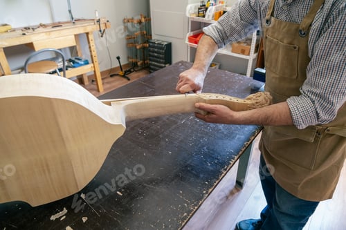 Preview: Luthier working on cello making in his workshop