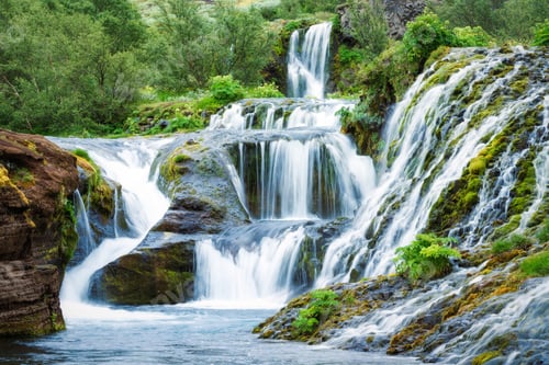 Preview: Gjain waterfall flowing with lush jungle in Pjorsardalur valley on summer at South of Iceland