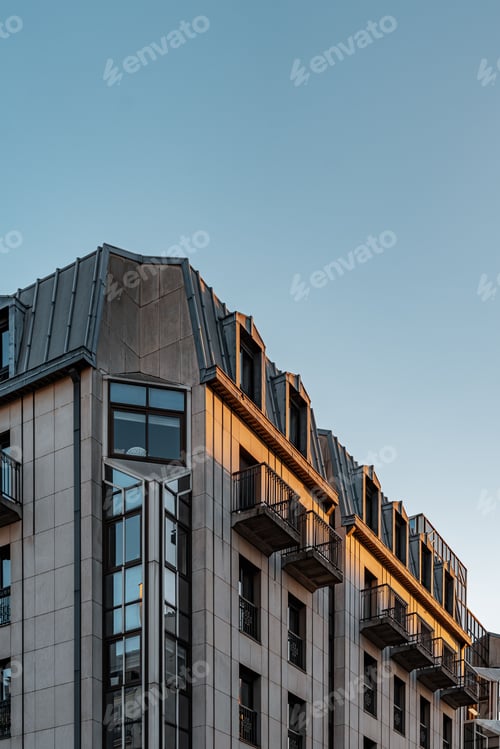 Preview: Apartment building with balconies lit in soft evening sunlight