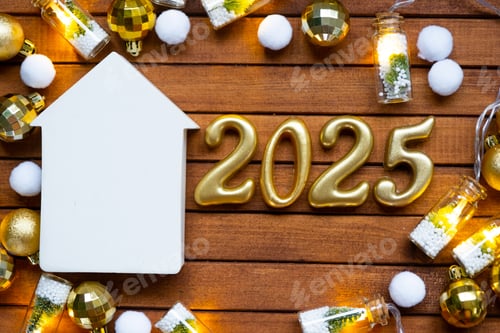 Preview: House key with tiny figure of home mock up on festive brown wooden background, lights of g insurance