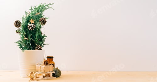 Preview: Creative natural miniature Christmas tree in pot on wooden table with gift boxes and white