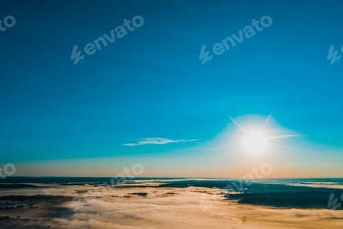 Preview: Aerial view of a beautiful summer landscape with a fog while dawn. Photo from drone.