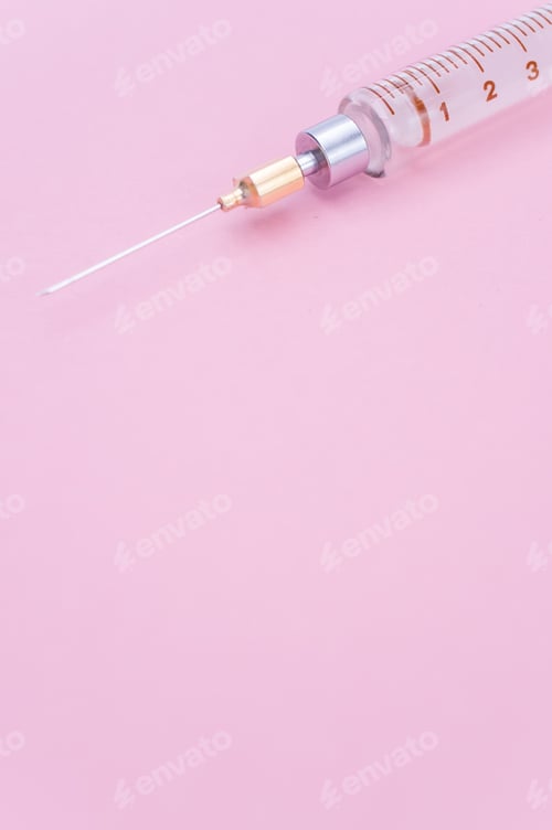 Preview: isolated sterilized glass injection syringe on a lilac paper background