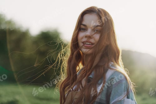 Preview: Portrait of a woman with a beautiful smile and straight teeth on a summer day in the sunset with