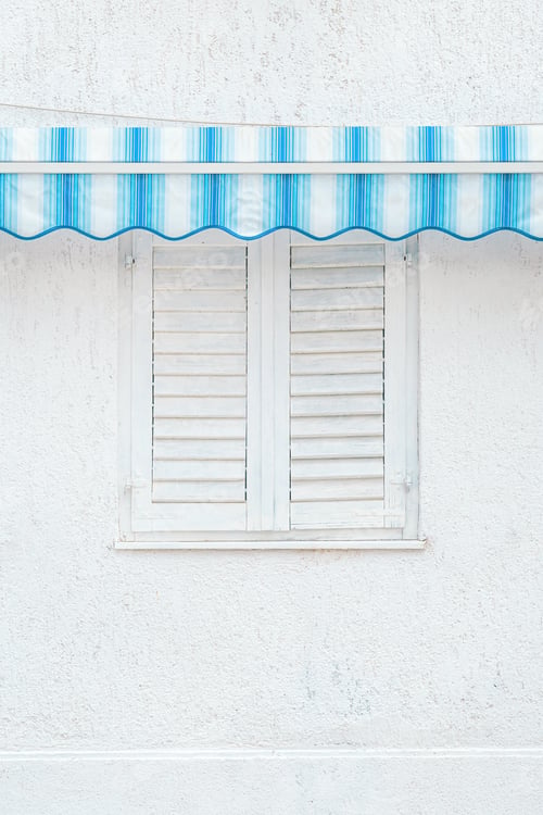 Preview: Closed white window shutters with blue awnings, detail from croatian seaside