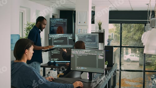 Preview: Diverse team of database developers analyzing code on terminal window