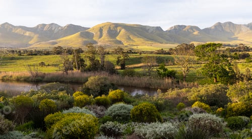 Preview: View across a tranquil landscape, river valley and a mountain range
