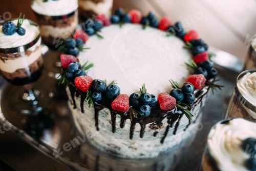 Preview: Wedding cake decorated with fresh blueberries, strawberries and chocolate