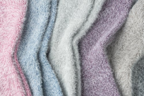 Preview: Close-up of fluffy cashmere and mink socks texture in soft pastel colors highlights gentle fibers