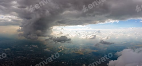 Preview: Aerial view from airplane window at high altitude of distant city