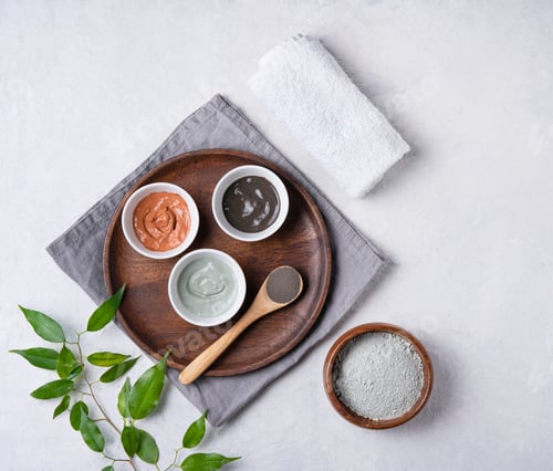 Preview: several types of cosmetic clay pink, green and gray with lavender on a gray concrete background