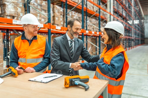 Preview: Manager shaking hands with worker in logistics warehouse