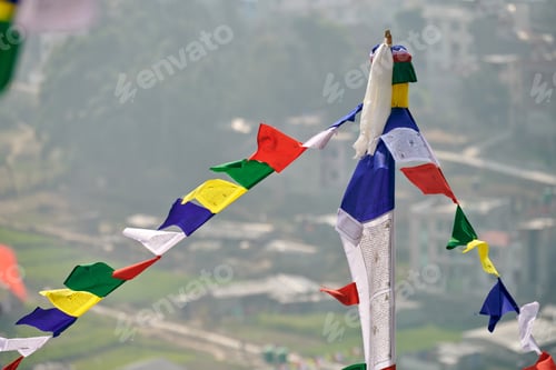 Preview: Colorful Tibetan prayer flags on blurred Kathmandu cityscape background