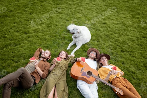 Preview: Friends lying together on the green lawn