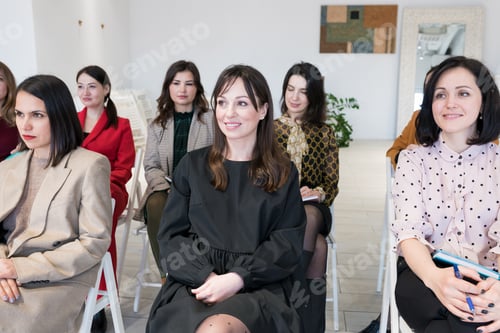 Preview: People listening to coach having speech at business training