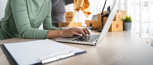 Preview: Startup small business owner working with computer at workplace. Two woman seller check product