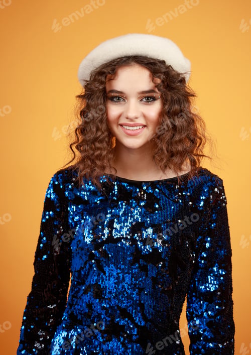 Preview: Vertical portrait of beautiful girl smiling on orange background