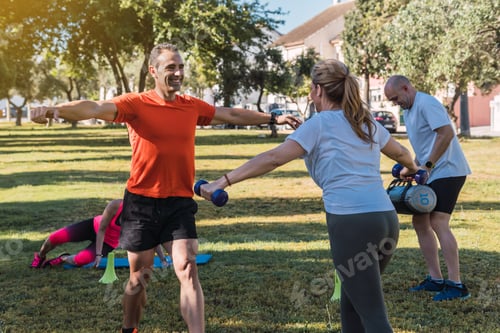 Preview: People doing exercises with a personal trainer outdoors