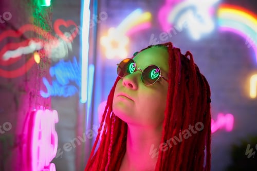 Preview: Girl in neon lights, beautiful woman in sunglasses, with pink hair, with dreadlocks pigtails