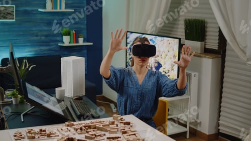 Preview: Architect using vr glasses for building design with blueprint