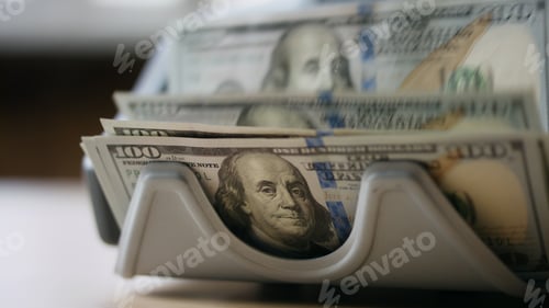 Preview: Electronic counter calculating dollar banknotes close up. Money cash calculation