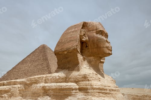 Preview: Majestic sphinx sculpture stands guard in front of the iconic pyramids of Giza, Egypt.