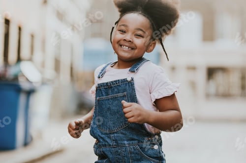 Preview: Happy African-American girl running on the street