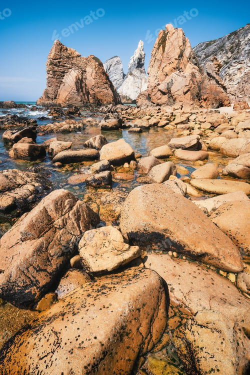 Preview: Rocky coastline of Praia Da Ursa beach, Sintra, Portugal. Giant sea stacks towering up from atlantic