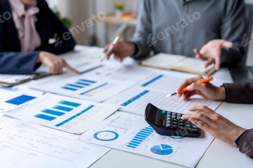 Preview: Business Professionals Reviewing Charts and Graphs Together