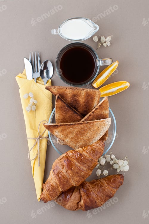 Preview: Black coffee, milk, croissants and toast close-up on a light bro